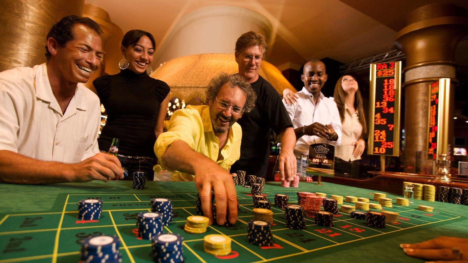 Players celebrating around a roulette table